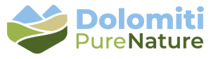 logo dolomiti pure nature a white rectangular sign with a colorful star and black text